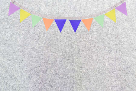 Flag garland on grey fabric texture background, blank grey fabric pattern background