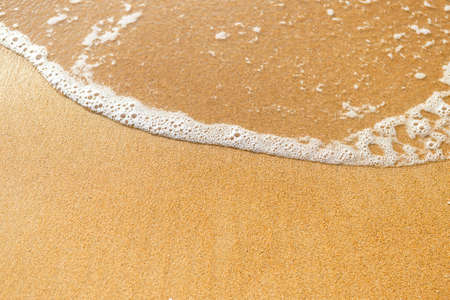 Closeup sandy beach background, fine sand with white wave, nature background, summer outdoor day lightの写真素材