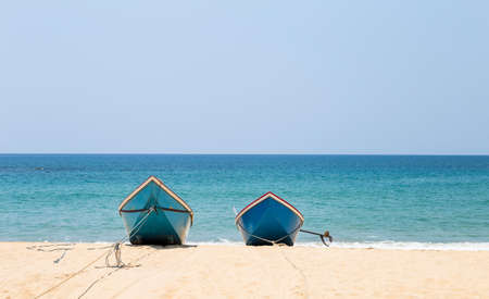 Two fishing boat on the beach, travel to asia, tropical island, empty clean beach in summer seasonの写真素材