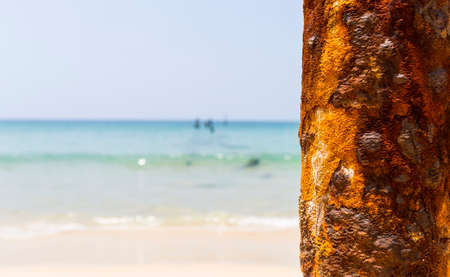 Rusty pillars over Summer beach background, outdoor day light, empty clean fine sandy beach, tropical islandの写真素材