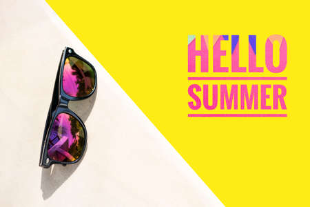 Hello summer banner on yellow background with sunglasses, first day of summer holiday, colorful summerの写真素材