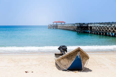 Fishing boat on the beach with Concrete pier on background, travel to asia, tropical islandの写真素材