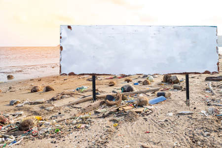 Blank sign board on dirty beach in Thailand, garbage from the sea on the beach, environment problem...