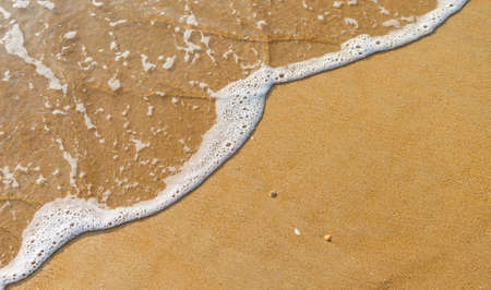 Closeup sandy beach background, fine sand with white wave, nature background, summer outdoor day...