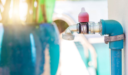 Plastic faucet over blurred background, clear plastic water tapの写真素材