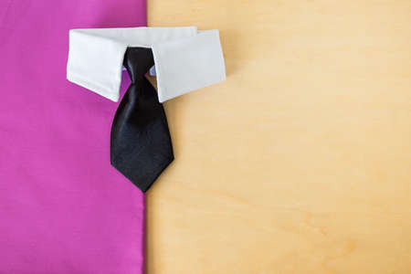Classic black necktie with white collar shirt on purple fabric and wooden background, business and male fashion concept backgroundの写真素材