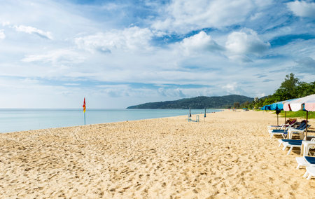 Row of beach chairs on tropical island in south of Thailand, tourist attraction in Asia, holiday destination paradise islandの写真素材