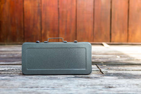Metal tool box with space on wood background, simple design grey tool boxの写真素材