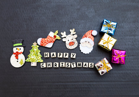 Happy Christmas sign with Santa clause and reindeer with gift box with black texture background,...