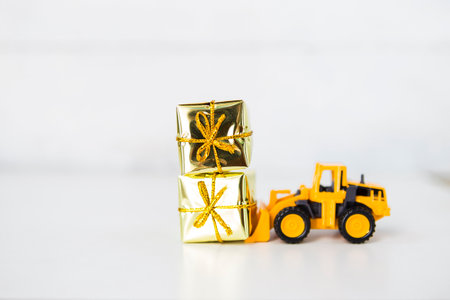 Yellow truck toy with two gift box with space on white background, Christmas and New year concept backgroundの写真素材