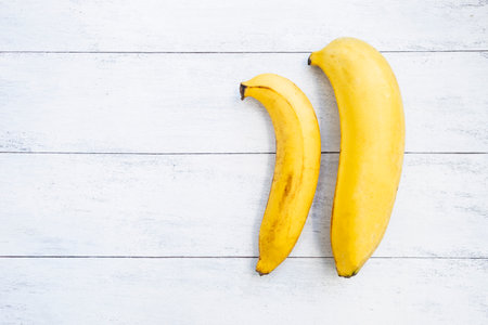 Banana on white wood texture background, diet food concept, healthy foodの写真素材