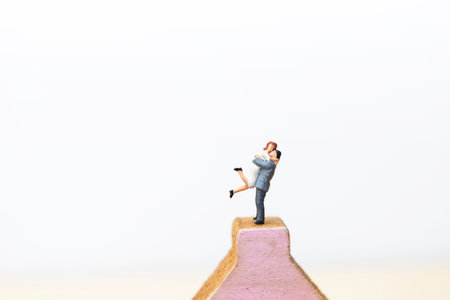 Miniature couple with space on white background, love and romance, valentine background idea, wedding backgroundの写真素材