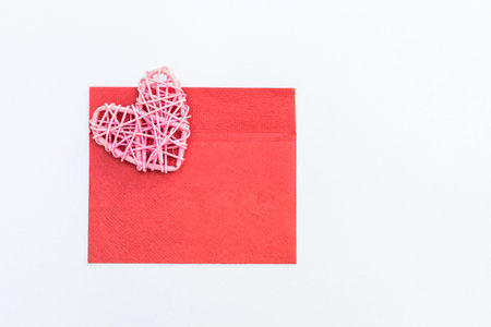 Pink wooden heart on red envelope isolate on white background, velentine card background idea