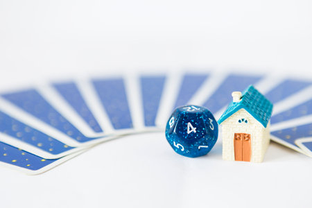 Blue dice divination with miniature hosue and tarot card on background, astrological dices fortune telling divination tools, forth house of astrology, selective focusの写真素材