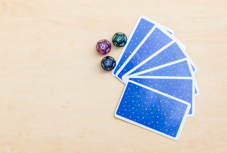 Dice divination with tarot card with space on wood background, astrology dice fortune telling divination toolsの写真素材