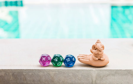 Ganesh sculpture over blurred water background, outdoor day light, peaceful and happiness conceptの写真素材