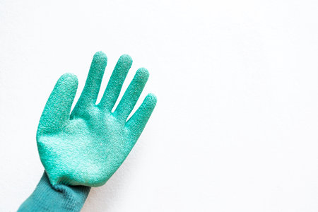 Green plastic gardening gloves on white background, hand protectionの写真素材