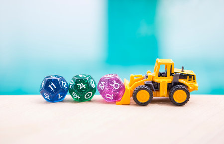 Yellow toy truck with dice divination on blurred water background, astrological dices fortune telling divination tools, 11 house and Taurus zodiac sign and Jupiter symbolの写真素材