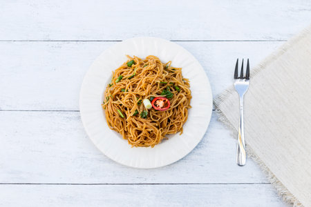 Stir-fried Thai rice noodle on wooden table background, Pad khanom jeen in Thai name, simple asian fried noodleの写真素材