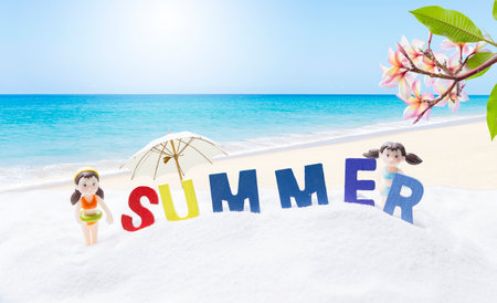 Summer holiday background idea, colour summer sign with miniature girl on tropical beach background, outdoor day lightの写真素材