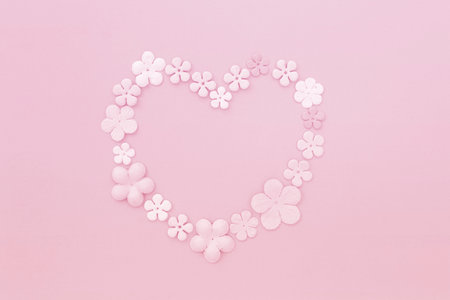 Pink card with paper flower in heart shape, valentine card background ideaの写真素材