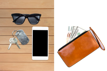 Cash in brown wallet isolate on white background, sunglasses and smartphone with house key on wooden...