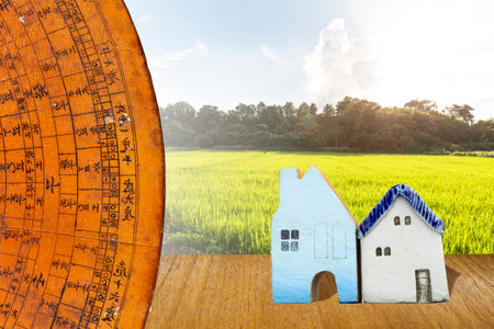 Old wooden Chinese feng shui compass over rice field in Thailand background, property industry, real estate investment, house feng shuiの写真素材