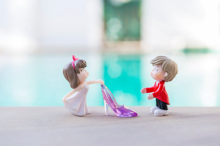 Miniature couple with purple high heels shoe over blurred background, outdoor day light, wedding dayの写真素材
