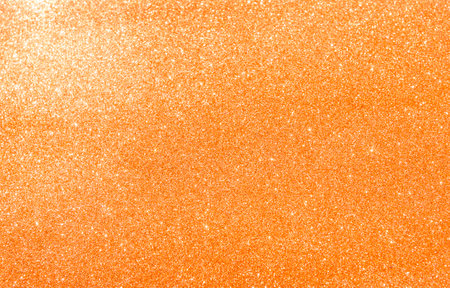Abstract blank orange glitter texture background, shiny orange glitter backgroundの写真素材
