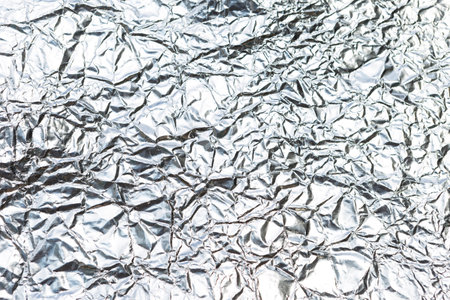Abstract crumpled silver paper texture background, blank wrinkle paper pattern backgroundの写真素材
