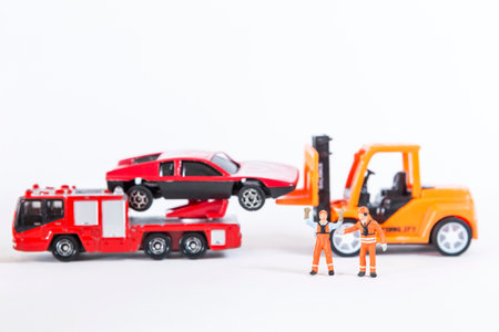 Miniature worker with car broke down isolate on white background, insurance business concept, road side assistanceの写真素材