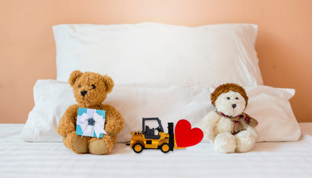 Two teddy bear sitting in the bed, no communication relationshipの写真素材
