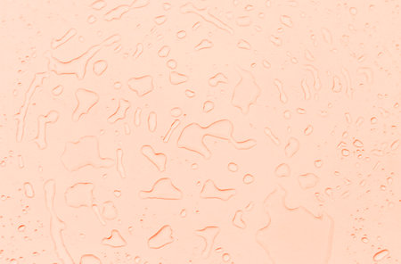 Abstract water drops on orange background, orange water drops pattern backgroundの写真素材