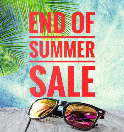 End of summer sale banner with sunglasses over blurred tropical tree bakground, summer promotion poster background ideaの写真素材