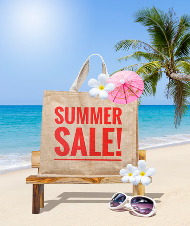 Summer sale on jute bag with wooden bench and sunglasses on tropical beach