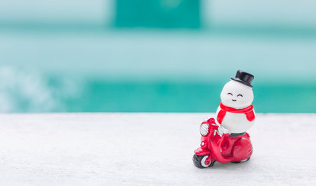 Snowman on red scooter with space on blurred background, Christmas card background ideaの写真素材