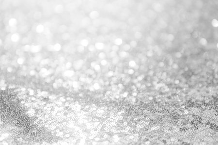 Abstract blurred light bokeh on grey background, festive season concept background, blank silver...