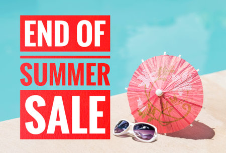 End of summer time banner with red paper umbrella on swimming pool edge, summer season concept