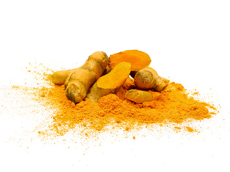Fresh turmeric slices and powder isolated on white background