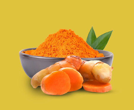 Turmeric powder in  bowl with turmeric sticks isolated on  yellow background.