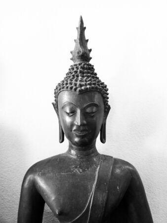 Buddha statue, half black, white background, asia, old,thailandの写真素材