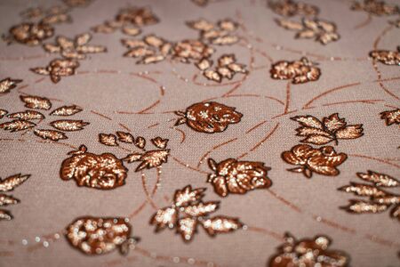 Patterned on fabric, on brown backgroundの素材