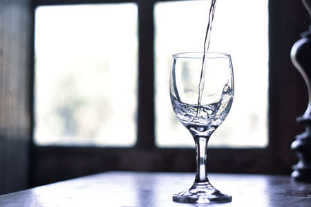 Pour water into a glass of water and bubble with copy spaceの写真素材