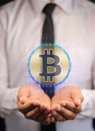 businessman holding bitcoins or cryptocurrency screen and coin cryptography