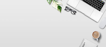Laptop and office supplies on white background. Top view with copy space