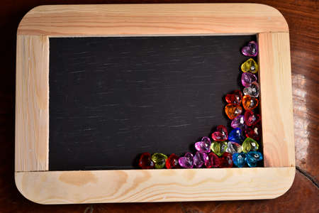 Vintage slate chalk board on wooden backgroundの写真素材