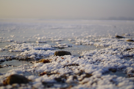 Thin, transparent ice and snow on a frozen lake in Bavariaの写真素材