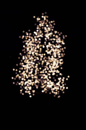 Blurring lights bokeh background of stars at christmastimeの写真素材