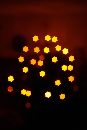 Blurring lights bokeh background of stars at christmastimeの写真素材
