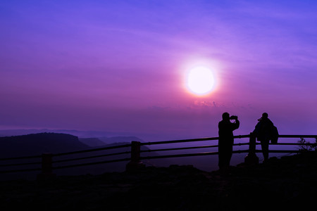 Silhouette Filter and Soft of Focus : Man is taking photos of his wife on sunrise landscape backgroundの写真素材